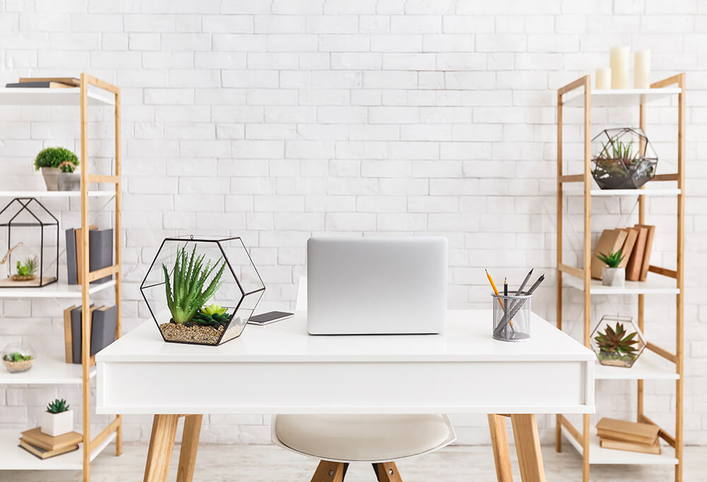 home office workspace with neat and tidy clear desk lots of plants and light no clutter organised comfortable for working from home